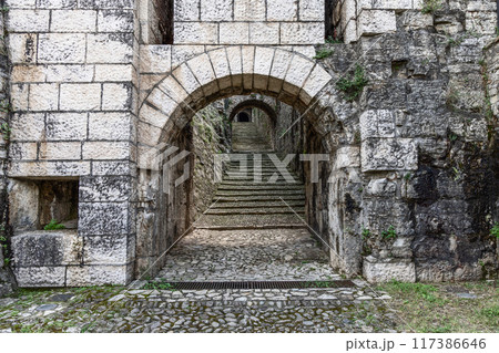 Detailed stone archway leading to Strada del Soccorso in Brescia Castle with visible staircase depth Detailed stone archway leading to Strada del Soccorso in Brescia Castle with visible staircase depth 117386646