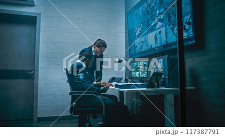 Female security worker have discussion with colleague in monitoring center 117387791