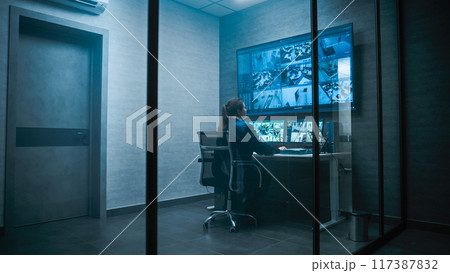Female security worker have discussion with colleague in monitoring center 117387832