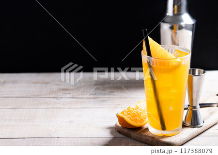 Orange vodka cocktail on wooden table and black background 117388079