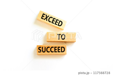 Exceed to succeed symbol. Concept words Exceed to succeed on beautiful wooden blocks. Beautiful white table white background. Business and exceed to succeed concept. Copy space. 117388728