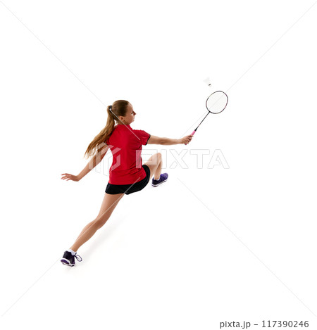 High angle view of young woman, badminton player hit shuttlecock, leaping forward against white studio background. 117390246