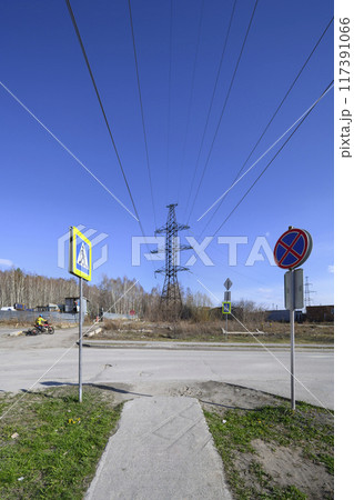 The tower of a high-voltage power line on the industrial outskirts of the city in spring 117391066
