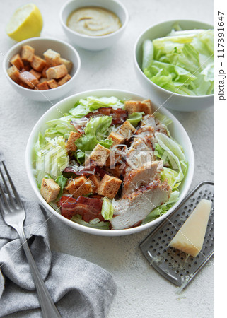 A bowl  of  Caesar salad 117391647