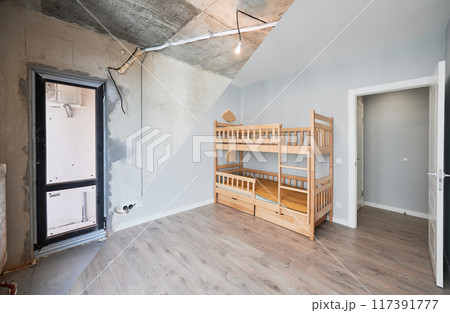 Comparison of children room with wooden bunk bed before and after restoration. Old apartment room with brick wall and new renovated flat with parquet floor and kid house bed. 117391777