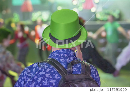 Man wearing a green hat enjoys lively dance event, St. Patrick's Day celebrations Man wearing a green hat enjoys lively dance event, St. Patrick's Day celebrations 117391990