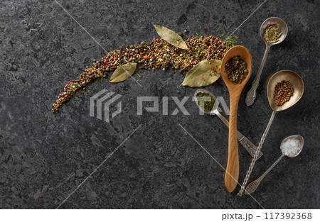 Mix of organic dried spices on a black stone background. Mix of organic dried spices on a black stone background. 117392368