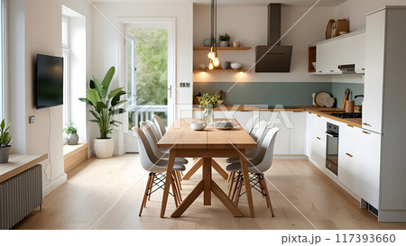 Modern scandinavian an eat-in kitchen interior design with big wooden table and chairs against light wood floor, bright white walls and furnitures with TV, appliances and hanging light bulbs Modern scandinavian an eat-in kitchen interior design with big wooden table and chairs against light wood floor, bright white walls and furnitures with TV, appliances and hanging light bulbs 117393660