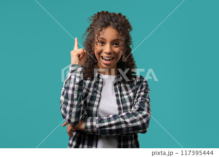 Genius creative idea, african teenager girl - eureka moment, pointing finger up Genius creative idea, african teenager girl - eureka moment, pointing finger up 117395444