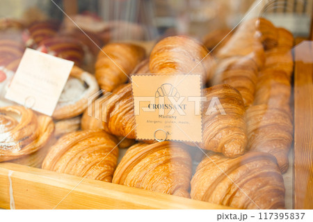 French breakfast. Close up of tray of freshly baked pastries, flavorful, warm, crispy gourmet croissants with powdered sugar, berry and cream. Bakery recipes. Concept of food, bakery, cuisine 117395837