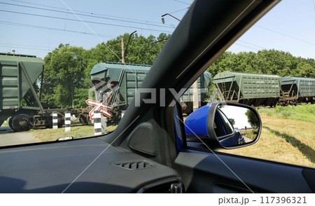 Closed Level Crossing With Moving Train View From Waiting Car  117396321