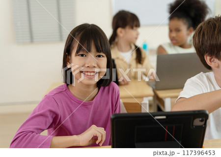Smiling Asian Girl Using Tablet in Technology Interactive Elementary Class in School Smiling Asian Girl Using Tablet in Technology Interactive Elementary Class in School 117396453