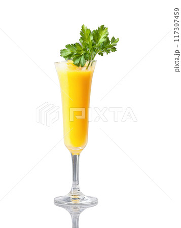 Spicy Mango Fruity yellow cocktail in a tall clear glass garnished with a slice 117397459