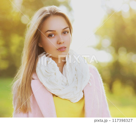 Portrait of beautiful blonde young woman looking at camera outdoors Portrait of beautiful blonde young woman looking at camera outdoors 117398327