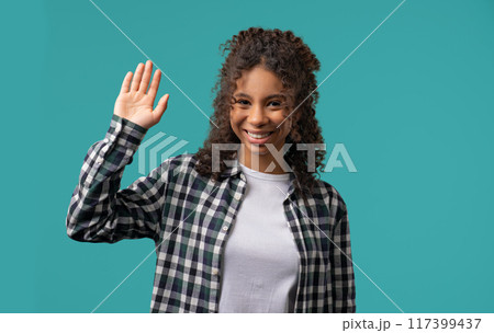 Friendly african eoman waving hand - Hello, Hi, Salute. Greetings on blue Friendly african eoman waving hand - Hello, Hi, Salute. Greetings on blue 117399437