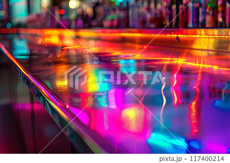 Colorful neon-lit bar interior with a reflective countertop and rows of bottles in the background 117400214