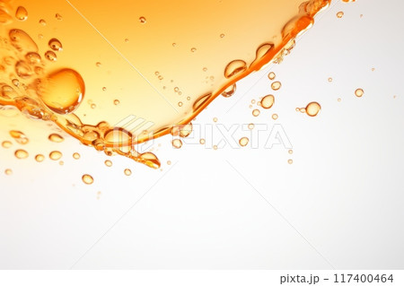 Orange liquid splash with bubbles and drops. 117400464