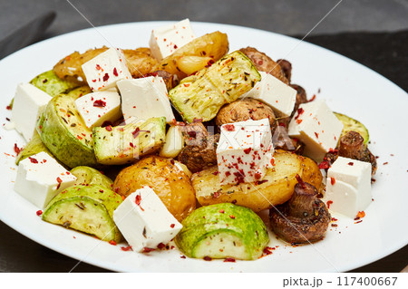 Roasted vegetable salad with feta cheese, seasoned with herbs and chili flakes for a flavorful bite Roasted vegetable salad with feta cheese, seasoned with herbs and chili flakes for a flavorful bite 117400667
