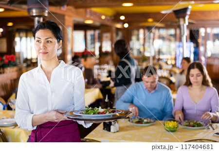Portrait of positive waitress in restaurant 117404681