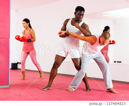 Sparring of two men at self-defense training in sports club 117404823