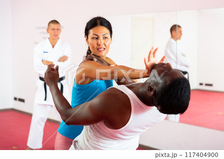 Punch to the head of a man during self-defense training for women Punch to the head of a man during self-defense training for women 117404900