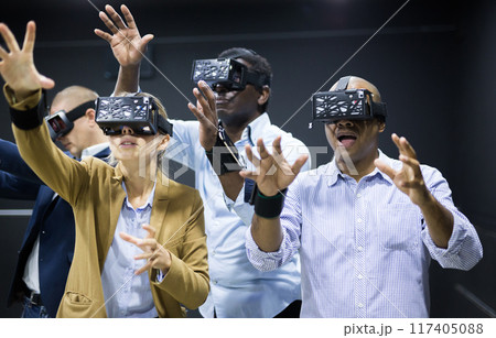 Multiethnic friends using virtual reality glasses 117405088