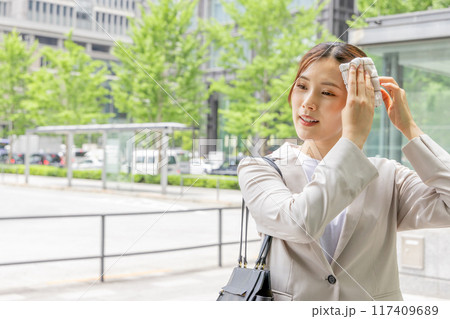 ハンカチで汗を拭くビジネスウーマン 117409689