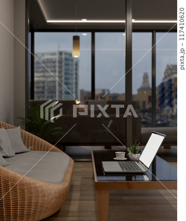 A side view of a laptop on a coffee table in the living room of a contemporary apartment. 117410620