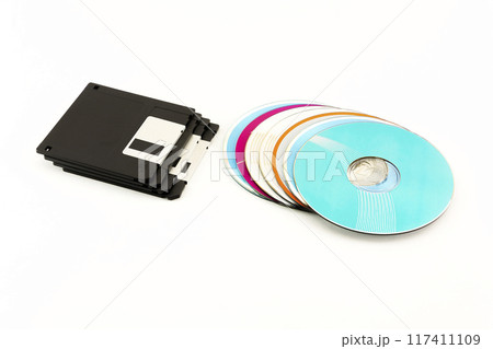 1.44 inch Floppy disks and CD / DVD discs lie on a white background 1.44 inch Floppy disks and CD / DVD discs lie on a white background 117411109