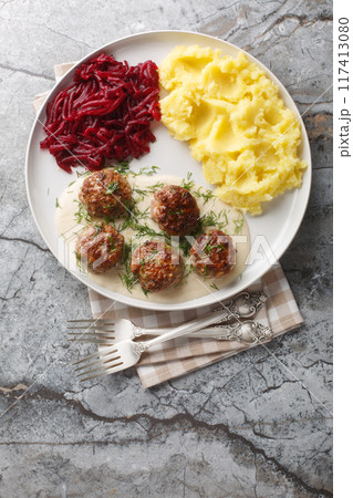 Polish Meatballs Klopsiki with mashed potatoes and beet salad close-up in a plate. Vertical top view Polish Meatballs Klopsiki with mashed potatoes and beet salad close-up in a plate. Vertical top view 117413080