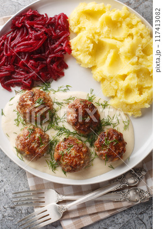 Meatballs with mashed potatoes and beet salad close-up in a plate. Vertical top view Meatballs with mashed potatoes and beet salad close-up in a plate. Vertical top view 117413082