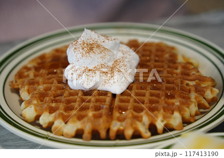 Waffles with whipped cream on a plate 117413190