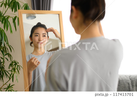 鏡の前に立つ20代の女性 鏡の前に立つ20代の女性 117413701