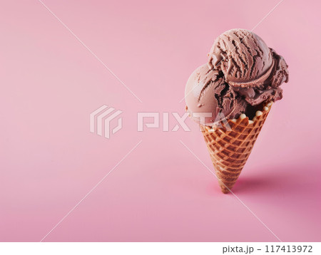 Chocolate ice cream in a waffle cone on pink background 117413972