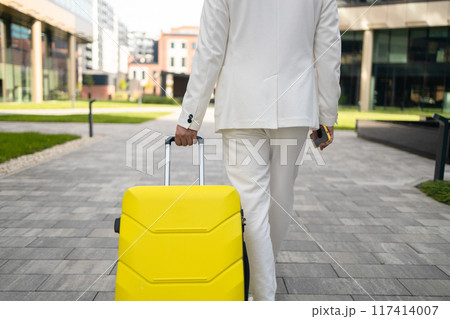 Close-up of male Caucasian hand holding travel bag. Unrecognizable young man arriving at hotel. Unknown client entering room with luggage. Travelling, tourism, business trip, lifestyle. Close-up of male Caucasian hand holding travel bag. Unrecognizable young man arriving at hotel. Unknown client entering room with luggage. Travelling, tourism, business trip, lifestyle. 117414007