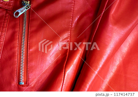 Part of a red leather jacket with a zippered pocket Part of a red leather jacket with a zippered pocket 117414737