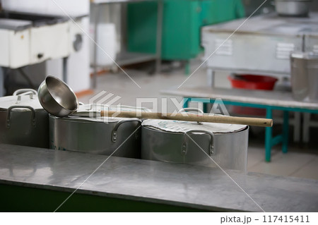 Large iron pans and a ladle Large iron pans and a ladle 117415411