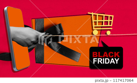 A phone is being used to cut a black ribbon, which is tied around a gift A phone is being used to cut a black ribbon, which is tied around a gift 117417064