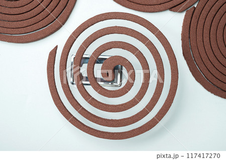Mosquito coils with a silver object in the middle 117417270