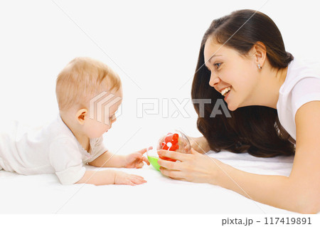 Portrait of smiling mother and baby playing with toys over a white background Portrait of smiling mother and baby playing with toys over a white background 117419891