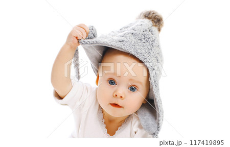 Portrait close up of cute baby wearing a winter knitted gray hat over a white background 117419895
