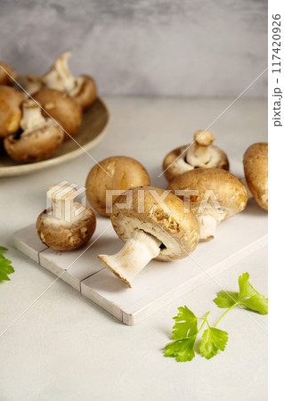 Raw champignon on bright background, button mushrooms. Vegan protein.  117420926