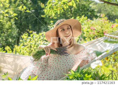 Young woman relaxing in a hammock 117421163