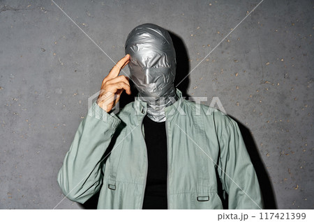 Mystery thoughtful man with duct tape face Mystery thoughtful man with duct tape face 117421399