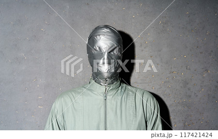 Mystery man with duct tape face wrap on gray background 117421424