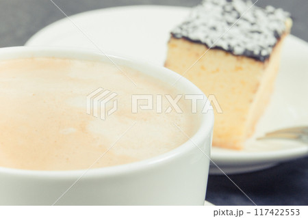 Cup of white coffee and fresh baked cheesecake. Delicious dessert 117422553