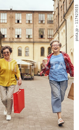 Joyful and happy seniors are enjoying a delightful day out together while shopping 117423033