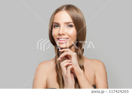 Cheerful young healthy woman with pigtail hairstyle and natural make-up on white background Cheerful young healthy woman with pigtail hairstyle and natural make-up on white background 117424203