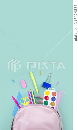 Back to school concept. School supplies are collected in a backpack. Pastel colors banner copy space vertical Back to school concept. School supplies are collected in a backpack. Pastel colors banner copy space vertical 117424882