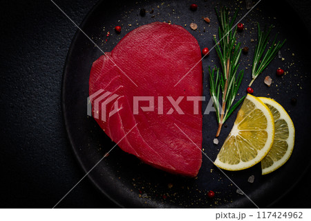fresh red tuna fillet, for steak, raw, top view, on a black plate , no people, 117424962